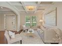 Bright living room features coffered ceilings, stylish decor, and plenty of natural light for a welcoming space at 9069 Blue Ridge Dr, Indian Land, SC 29707