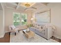 Cozy living room with coffered ceilings, large windows, and neutral decor provides a relaxing atmosphere at 9069 Blue Ridge Dr, Indian Land, SC 29707