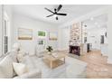 Bright living room featuring a brick fireplace, hardwood floors, and an open concept design at 103 Park Ave, Mount Holly, NC 28120
