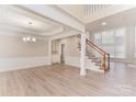 Bright living room with high ceilings and hardwood floors, with staircase at 10325 Merlin Meadows Ct, Charlotte, NC 28277