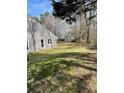 View of expansive backyard with lush greenery, mature trees, and natural surroundings at 104 Edgewater Nw Dr, Concord, NC 28027