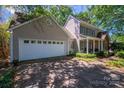 Charming home featuring a well-manicured lawn, two-car garage, and inviting front porch with green shutters at 107 Southfork Dr, Belmont, NC 28012