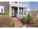 Inviting front porch with brick steps, fresh landscaping, and plenty of room to sit and relax at 11204 Arlen Park Dr, Huntersville, NC 28078