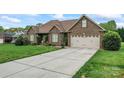 Brick home with a wide driveway and attached two-car garage, complemented by a well-maintained lawn at 132 Postell Dr, Statesville, NC 28625