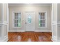 Bright foyer with hardwood floors, decorative door with sidelights, and classic white trim at 132 Postell Dr, Statesville, NC 28625