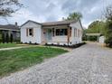 Classic single-story house featuring a gravel driveway and a tidy, inviting front lawn at 1421 Van Nuys St, Salisbury, NC 28144