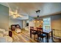 Open concept living area with hardwood floors, modern lighting and a dining area at 2006 Kollege Ln, Crouse, NC 28033