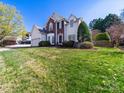 Two-story home with a well-maintained lawn, mature trees, and charming curb appeal at 20132 Tailwind Ln, Cornelius, NC 28031