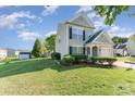 Two-story home with siding, a well-manicured lawn, and lush landscaping at 2409 Deberry Ct, Charlotte, NC 28213