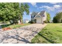 Well-maintained two-story home with a long driveway and mature trees at 2409 Deberry Ct, Charlotte, NC 28213