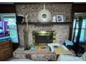 Close-up of a brick fireplace with decorative mantle and gold accents at 3452 Odell School Rd, Concord, NC 28027