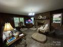 Spacious living room with brick fireplace, large windows, and ample natural light at 3452 Odell School Rd, Concord, NC 28027