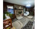 Inviting living room featuring a brick fireplace, tile floors, and natural light at 3452 Odell School Rd, Concord, NC 28027