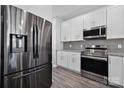 Close up of a kitchen featuring stainless steel appliances, and a gray backsplash at 4211 Center Place Dr, Harrisburg, NC 28075