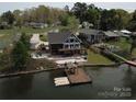 Waterfront home featuring a large dock and spacious outdoor entertainment area at 428 Pinehaven Dr, New London, NC 28127