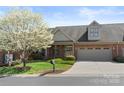 Charming brick home featuring a two-car garage and a lovely flowering tree at 489 26Th Ne Ave # C, Hickory, NC 28601