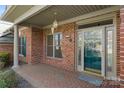 Inviting front porch with brick flooring and a stylish glass-paneled front door at 489 26Th Ne Ave # C, Hickory, NC 28601