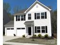 Charming two-story home features a two-car garage, well-maintained lawn, and classic architectural details at 5109 Arbordale Way, Mount Holly, NC 28120