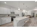 Bright kitchen features white cabinets, granite countertops, and stainless steel appliances at 5109 Arbordale Way, Mount Holly, NC 28120