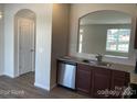 Modern kitchen features stainless steel appliances, granite countertops and arched doorway at 534 Dorman St, Belmont, NC 28012
