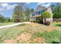 Charming two-story home featuring a two-car garage, a covered front porch, and a well-manicured lawn at 6010 Hawk View Rd, Waxhaw, NC 28173