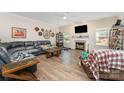 Spacious living room with a fireplace, TV, comfortable seating, and laminate wood flooring at 6010 Hawk View Rd, Waxhaw, NC 28173