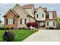 Inviting home with a well-maintained lawn, a curved driveway, and a beautiful front door entrance at 641 Weyburn Nw Dr, Concord, NC 28027