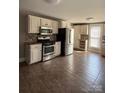 Open kitchen featuring stainless steel appliances, ample cabinetry, and spacious tile flooring at 705 3Rd Nw Ave, Hickory, NC 28601