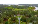 Beautiful aerial view of a wooded residential area with lake access and manicured lawns at 7268 Kiskadee Dr, Denver, NC 28037