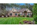 Charming brick home with a well-manicured lawn and inviting front entrance at 7268 Kiskadee Dr, Denver, NC 28037