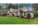 Well-maintained brick home with a lush green lawn and a welcoming facade at 7268 Kiskadee Dr, Denver, NC 28037