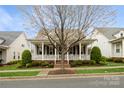 Lovely home highlighting a delightful front porch, verdant yard, and refined architectural features at 9514 Wheatfield Rd, Charlotte, NC 28277
