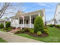 Attractive home boasting a cozy front porch, beautiful foliage, and traditional craftsmanship at 9514 Wheatfield Rd, Charlotte, NC 28277