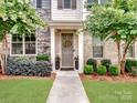 Inviting entryway showcasing a well-maintained facade with lush landscaping and a welcoming front door with wreath at 9710 Ainslie Downs St, Charlotte, NC 28273