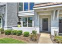 Charming exterior with a cozy porch, hanging chair, and a neat walkway to the front door at 1105 Reece Rd, Charlotte, NC 28209