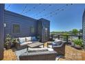 Inviting rooftop patio with comfortable seating, string lights, and city views at 1105 Reece Rd, Charlotte, NC 28209