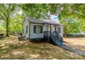 Exterior view of the side of a single story home with gray siding and a well maintained lawn at 111 Quinn Ave, Gastonia, NC 28054
