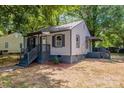 View of a single story home with gray siding, gray trim, and a covered porch entry at 111 Quinn Ave, Gastonia, NC 28054