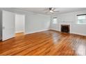 Bright living room featuring a fireplace, hardwood floors, and plenty of natural light at 1113 Gregory Ln, Statesville, NC 28677