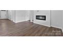 Living room featuring a modern fireplace and beautiful hardwood flooring at 1125 Hallman Branch Ln, Lincolnton, NC 28092