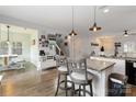 Open-concept kitchen with granite countertops, island seating, and modern pendant lighting at 1248 Century Dr, Clover, SC 29710