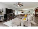 Spacious living room with fireplace, ceiling fan, and views into the kitchen at 1248 Century Dr, Clover, SC 29710