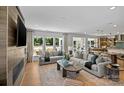 Bright open-concept living room with hardwood floors seamlessly leading to a kitchen and dining area at 130 Fordham Ct # 18, Fort Mill, SC 29715