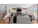 Inviting living room featuring a fireplace, hardwood floors, and comfortable seating under natural light at 130 Fordham Ct # 18, Fort Mill, SC 29715