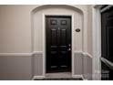 Apartment entrance with a black door featuring traditional hardware and visible unit number at 14849 Santa Lucia Dr, Charlotte, NC 28277