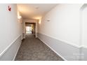Hallway view featuring neutral carpeting, wainscoting, and recessed lighting at 14849 Santa Lucia Dr, Charlotte, NC 28277