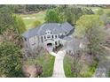 Beautiful aerial view of home with lush landscaping and golf course in background at 15603 Mccullers Ct, Charlotte, NC 28277