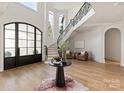 Elegant foyer with a grand staircase, high ceilings, and light hardwood floors at 15603 Mccullers Ct, Charlotte, NC 28277