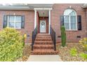 Inviting front entrance with brick steps and decorative wreath at 158 Canopy Oak Ln, Statesville, NC 28625