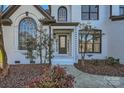 Inviting front entrance showcases a modern glass door and meticulous landscaping at 18038 Greyfield Gln, Fort Mill, SC 29707